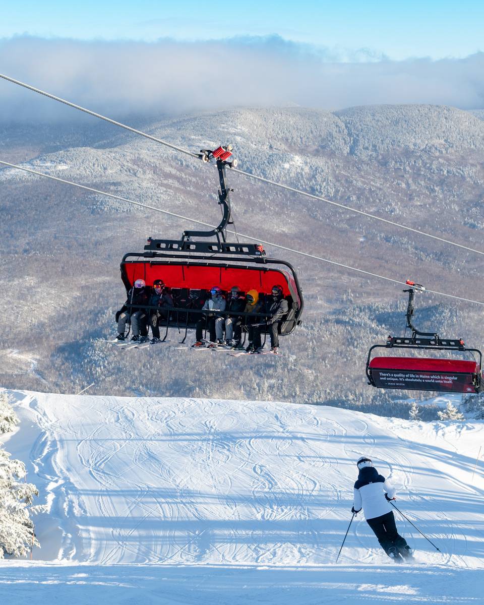 Skiers going down a trial with the Jordan 8 chairs over them at Sunday River.