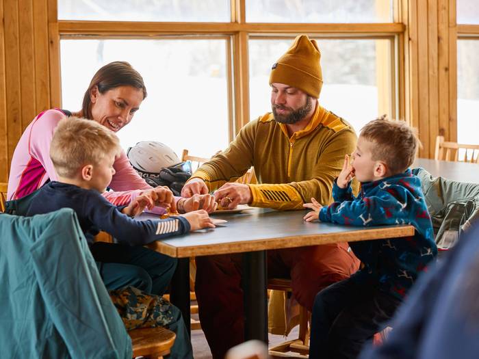 A family spending time together in a lodge at Sunday River.