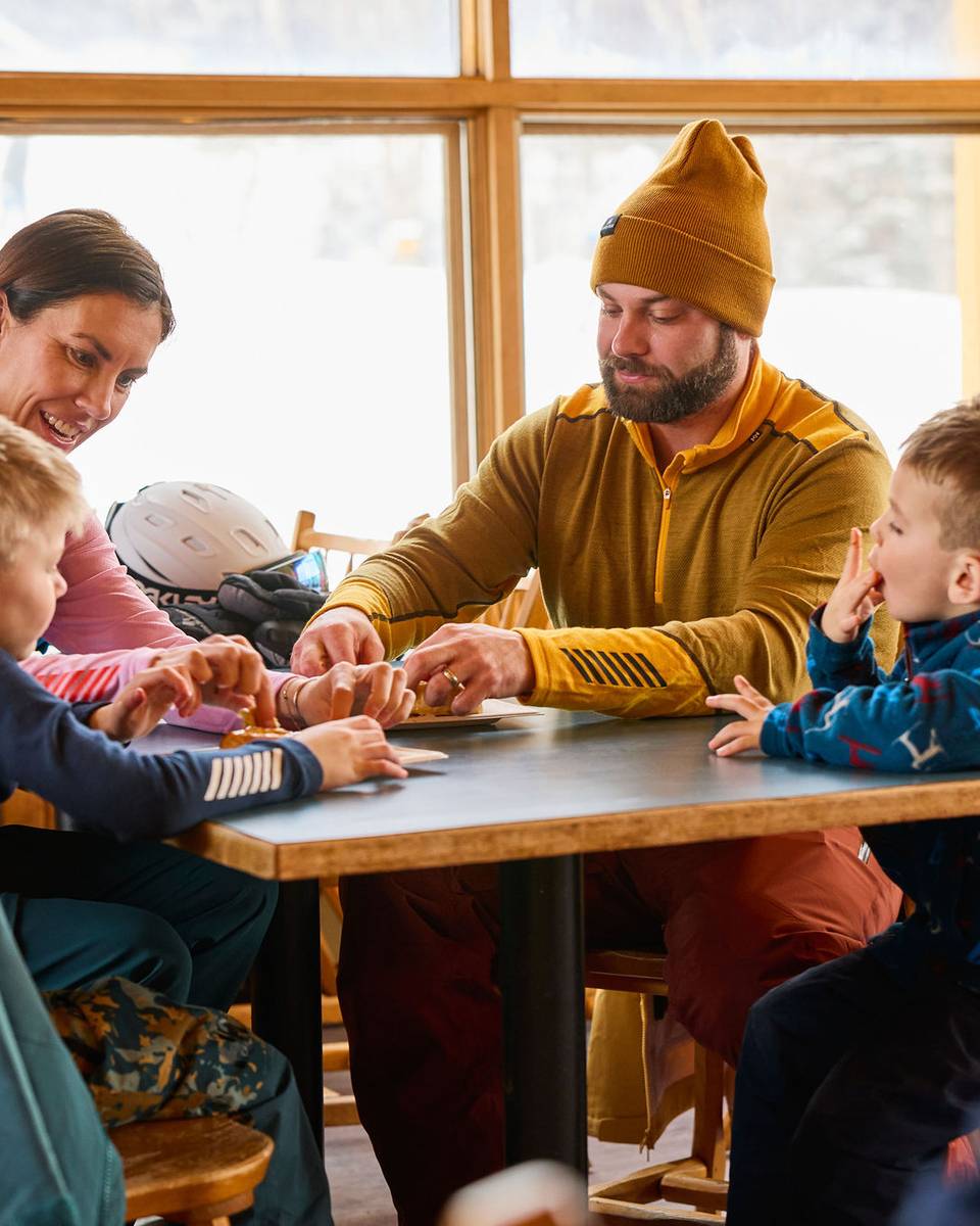 A family spending time together in a lodge at Sunday River.
