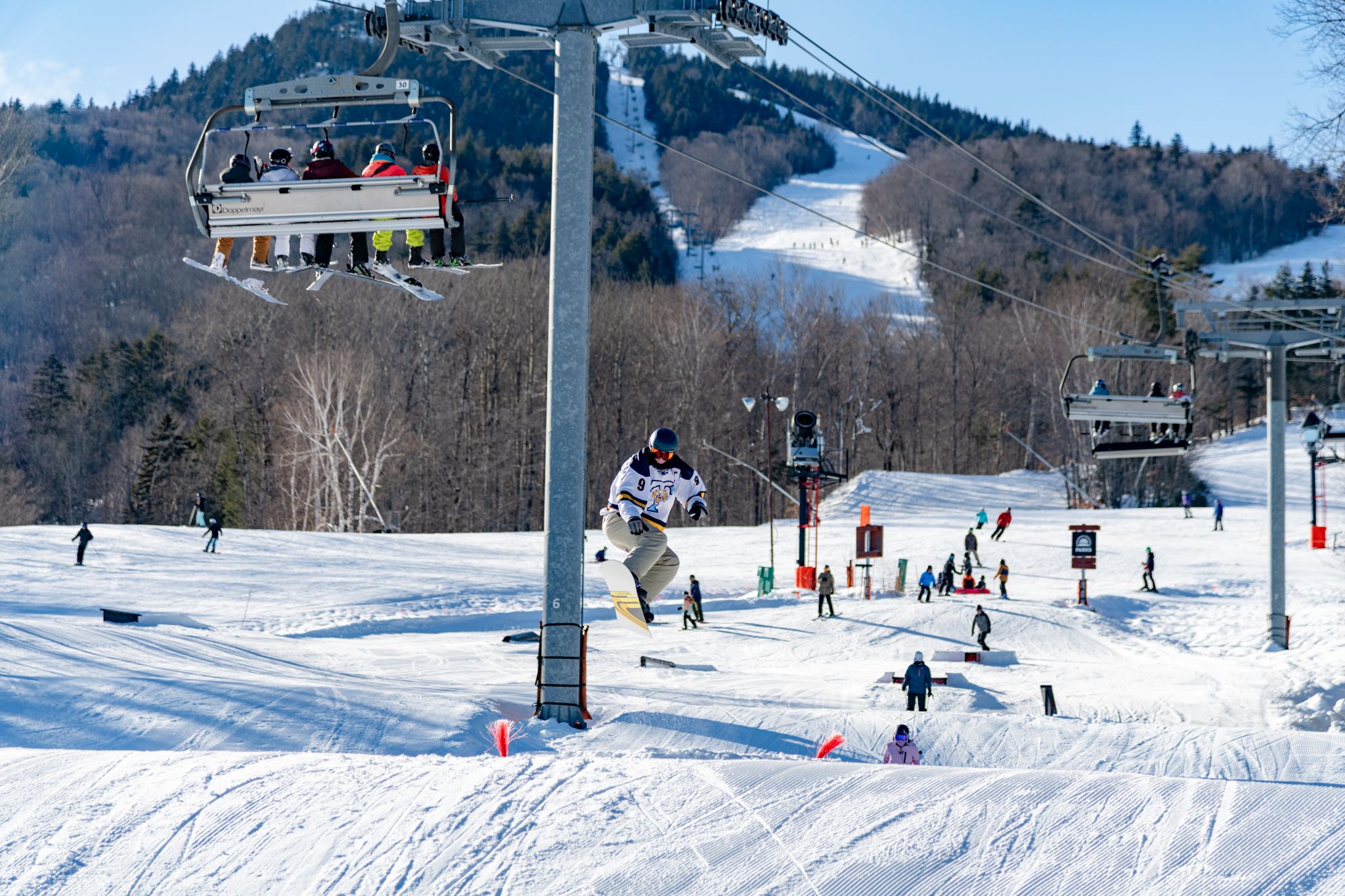 A groomer building a park feature at Sunday River.