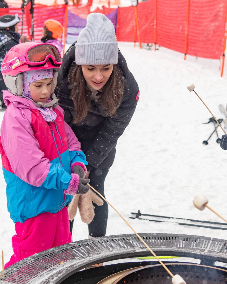 A little girl making a smore at Sunday River.