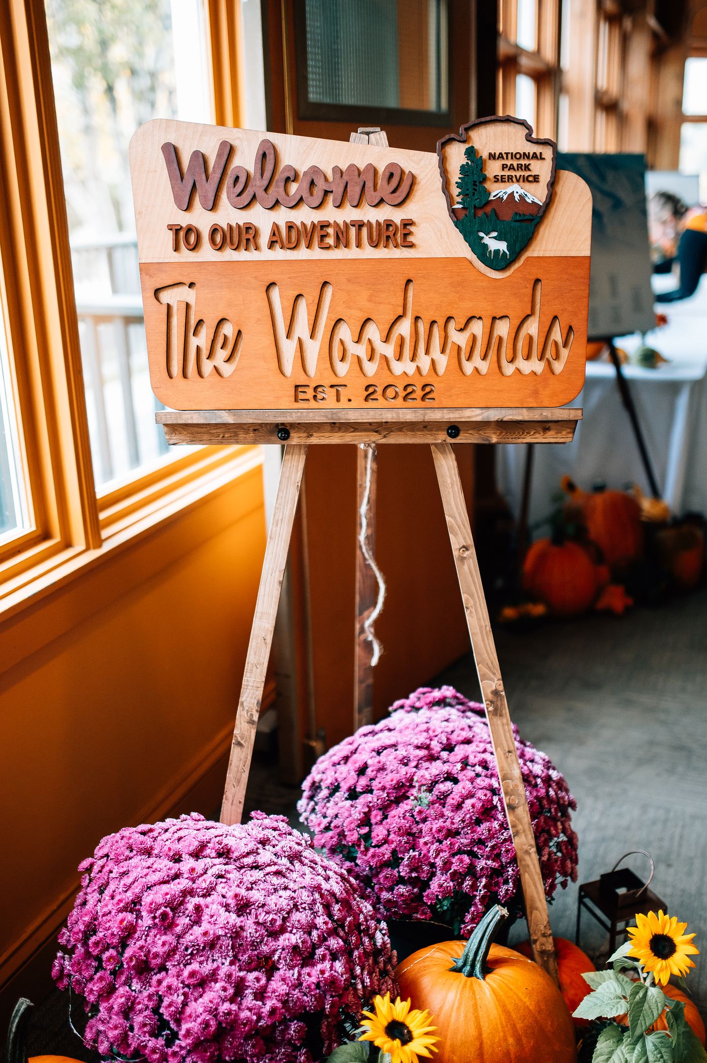 A welcome sign for a wedding with mums.