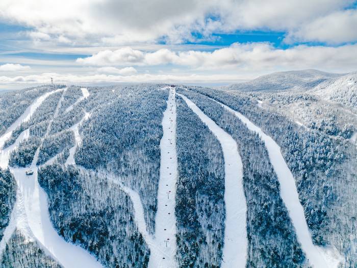 Snow covered trails around the lift line of Barker 6 at Sunday River.