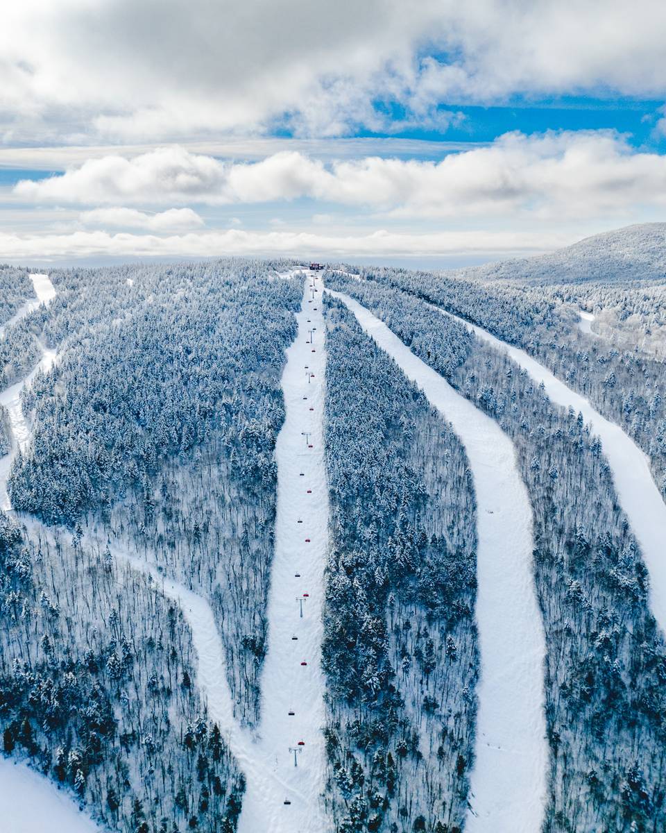Snow covered trails around the lift line of Barker 6 at Sunday River.