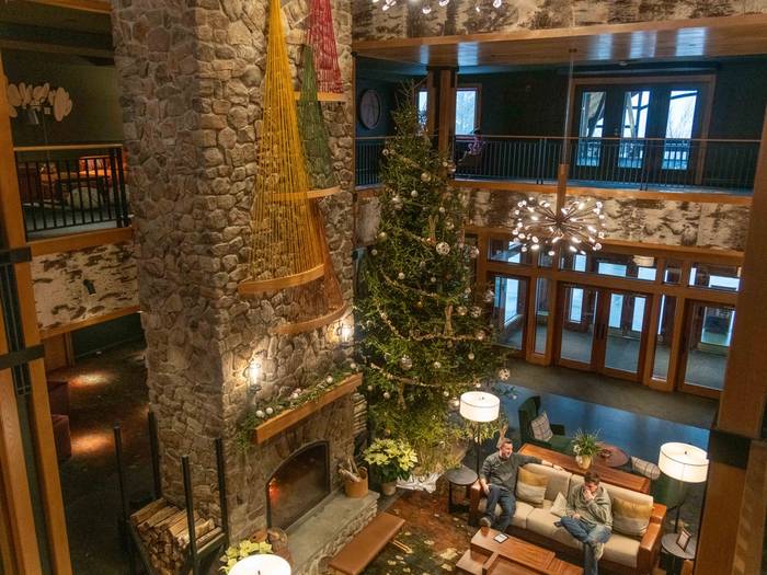People sitting in the lobby at The Jordan with a Christmas tree in the background.