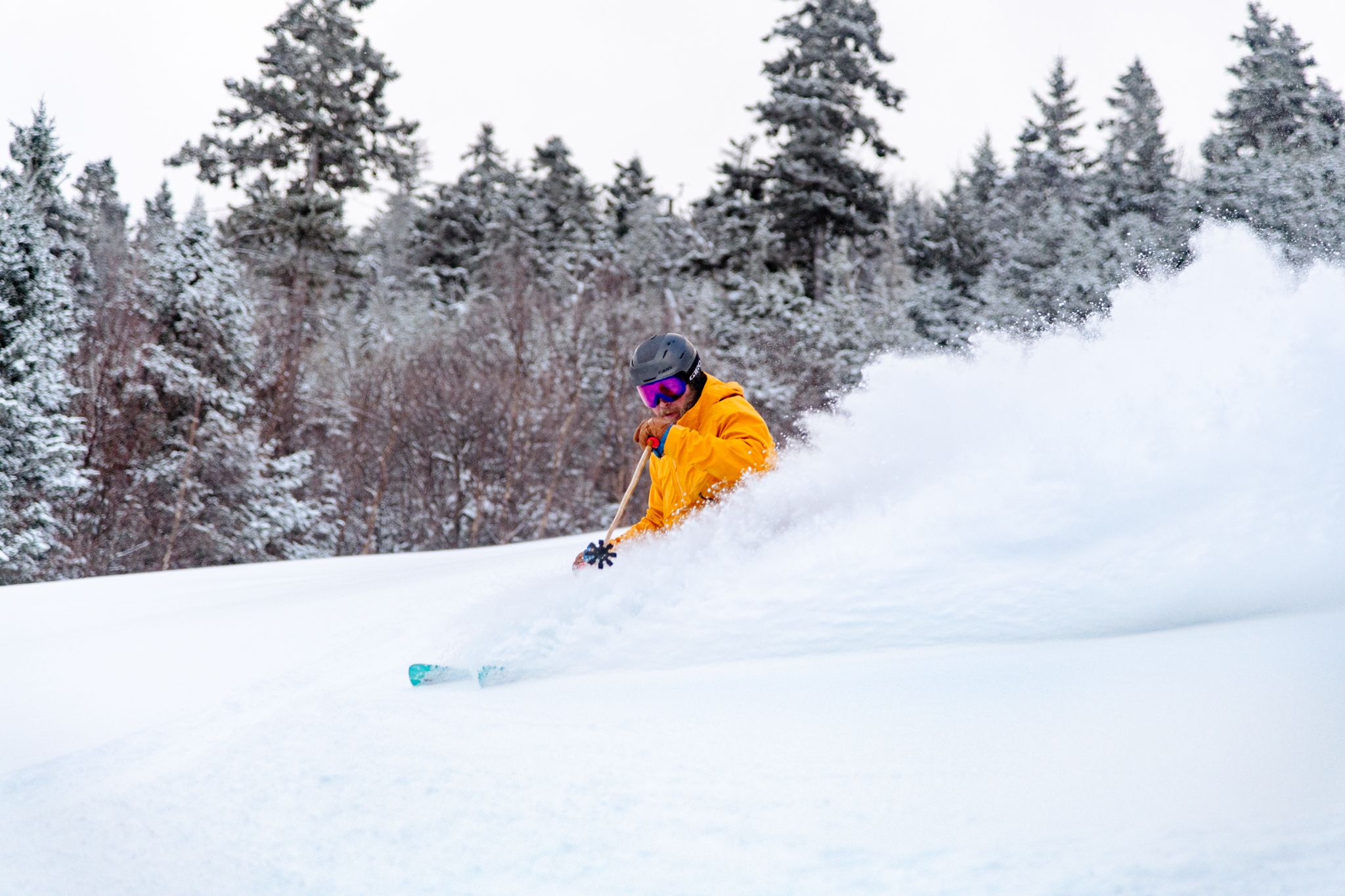 A person skiing in powder at Sunday River.