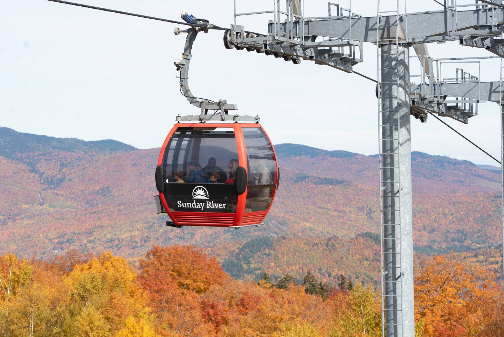 A group of people taking a Chondola ride at Sunday River's Fall Fest.