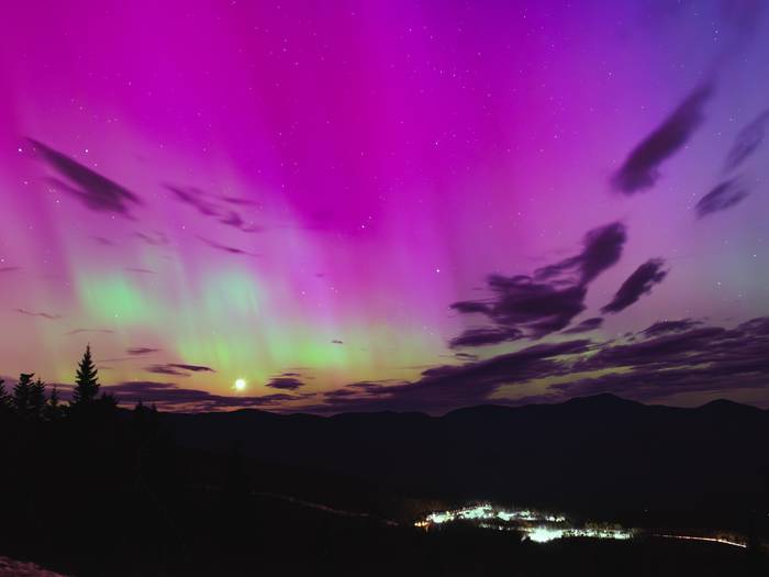 The Northern Lights, of red and green, over the Aurora Peak at Sunday River.