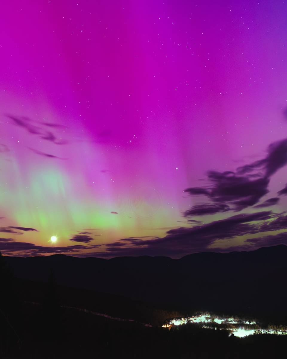 The Northern Lights, of red and green, over the Aurora Peak at Sunday River.