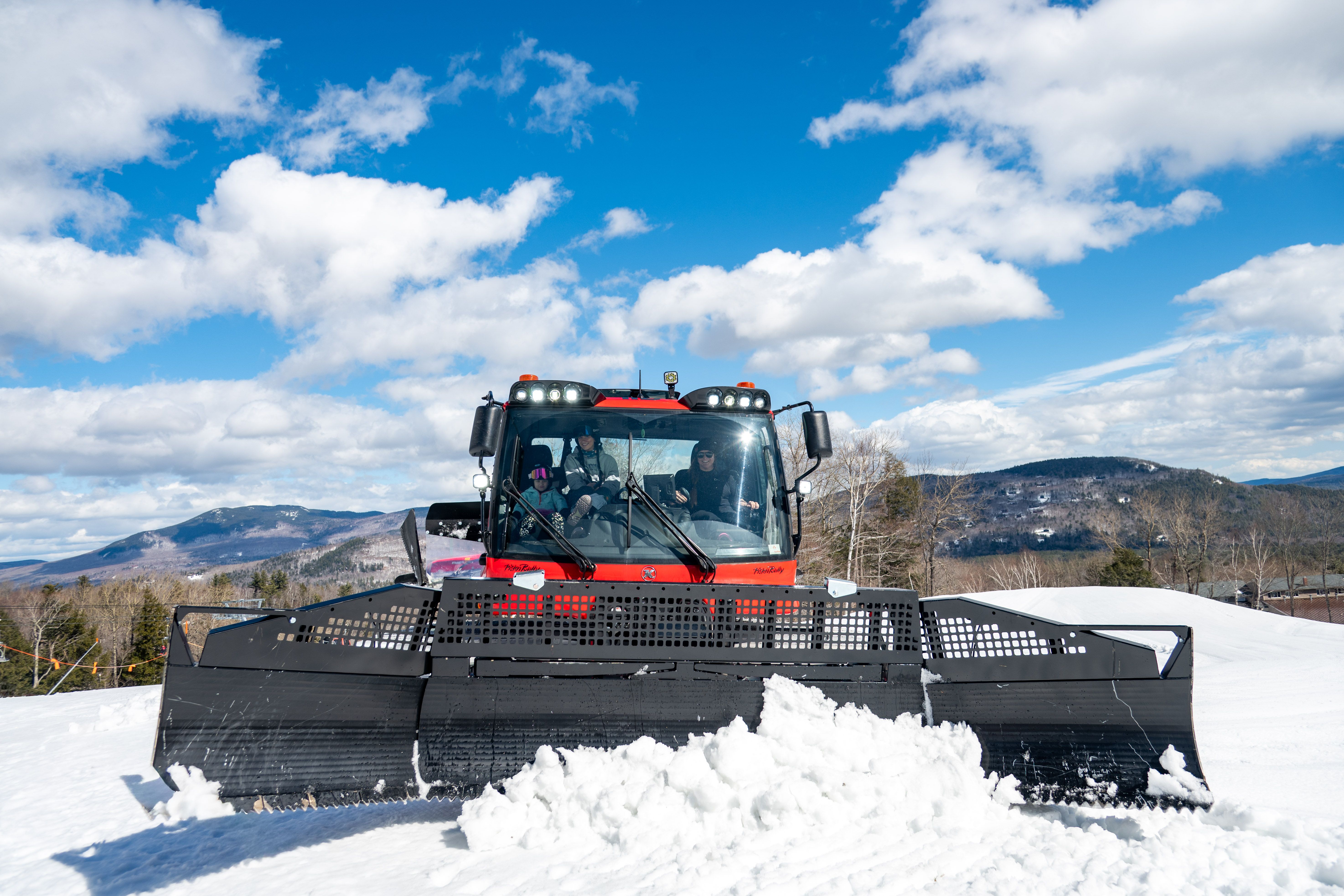 A person pushing snow during a demo at Sunday River.