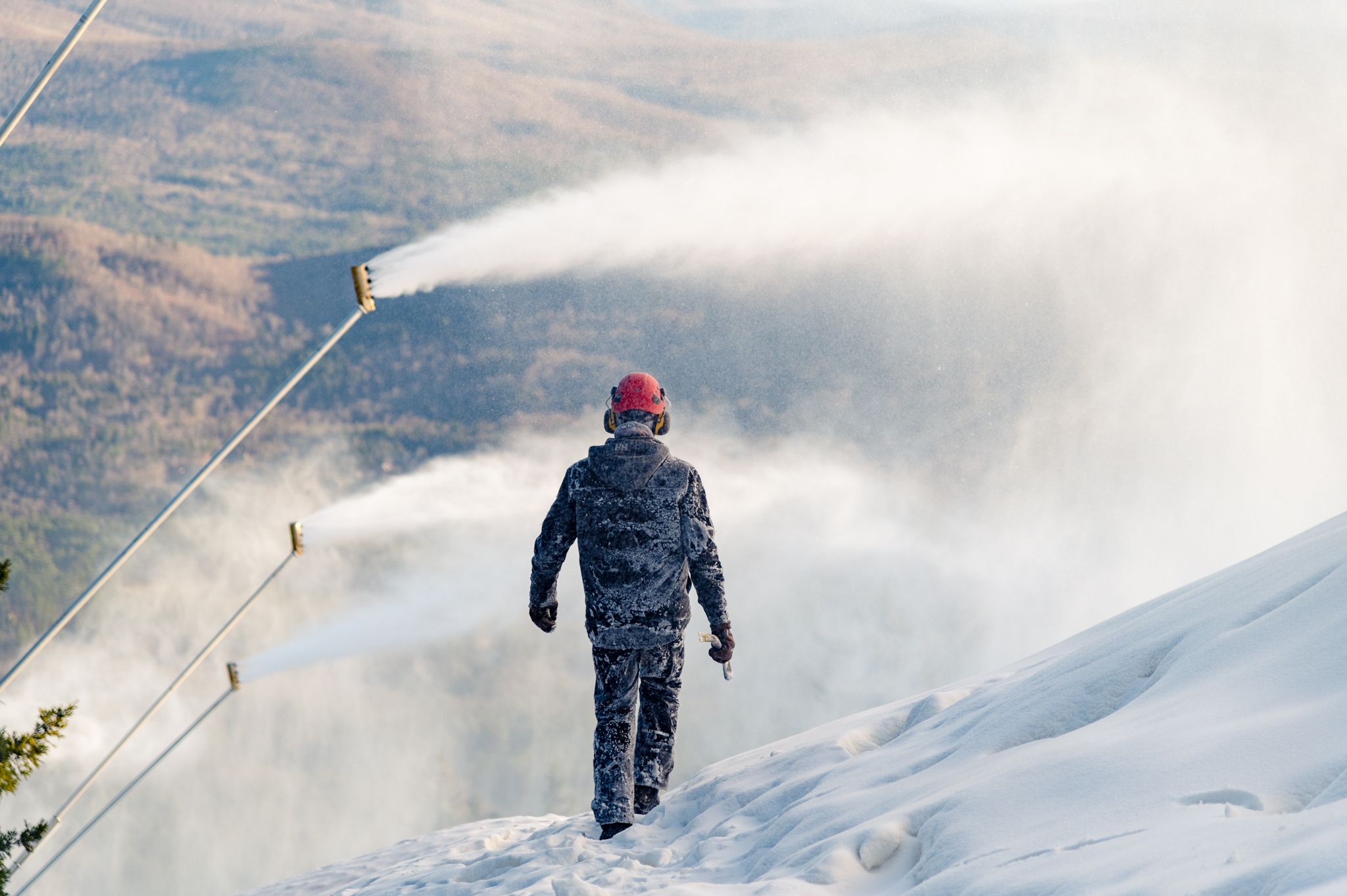 A snowmaker walking through snow at Sunday River.