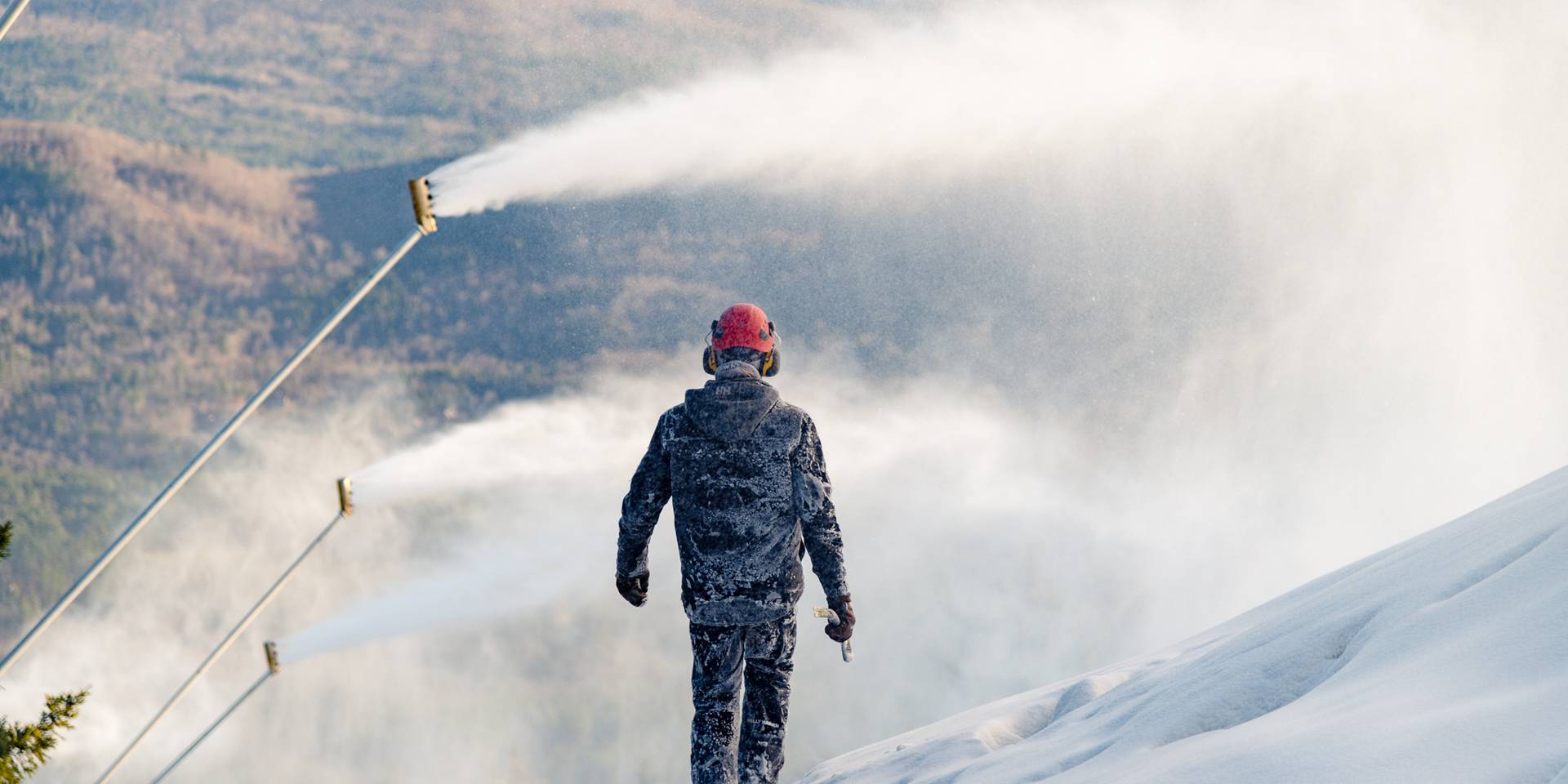 A snowmaker walking through snow at Sunday River.