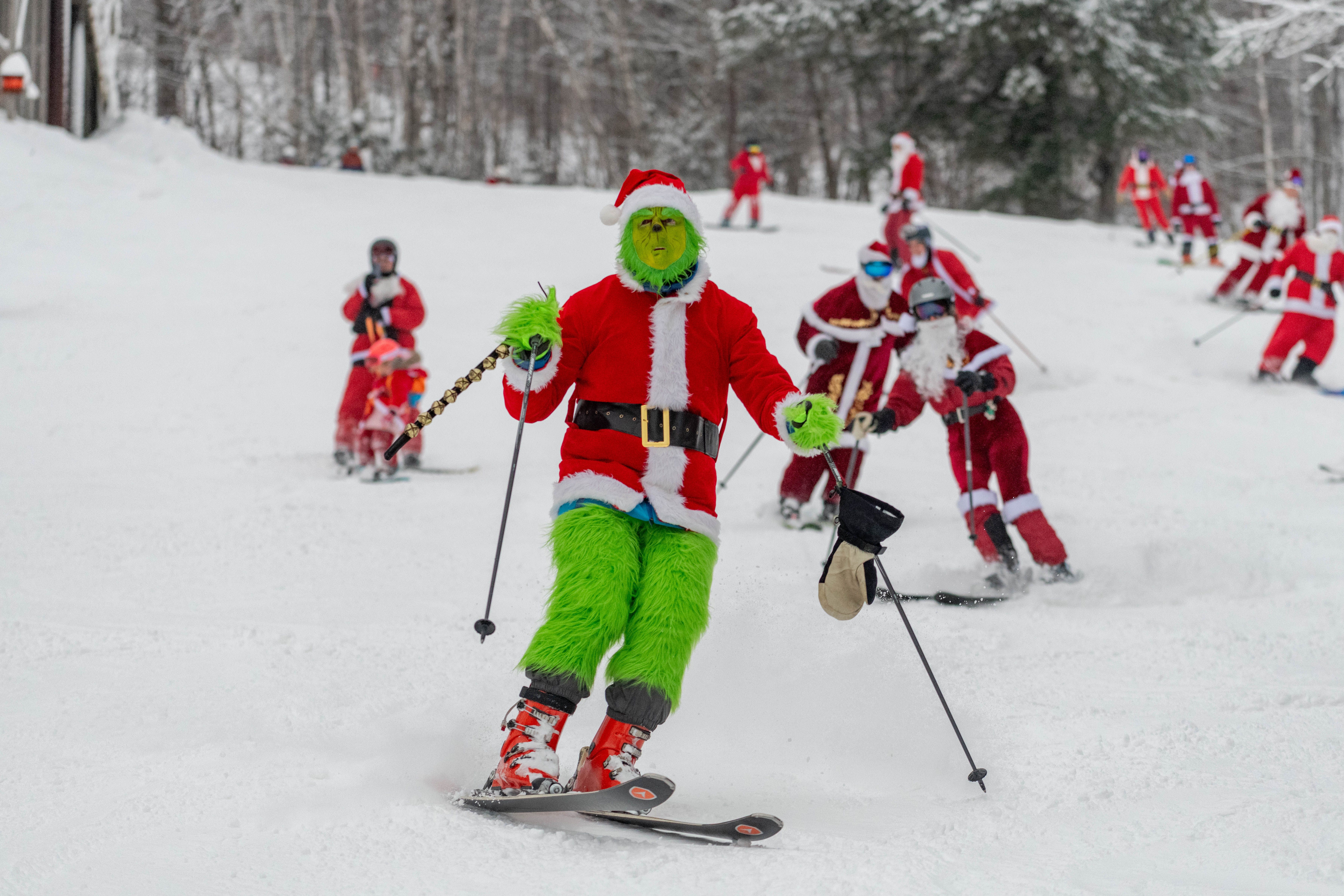 The Grinch skiing down a trail at Sunday River for Santa Sunday.