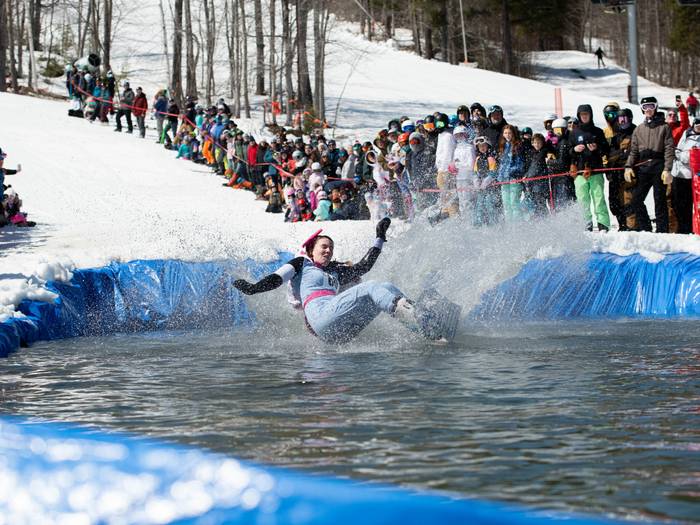 A snowboarder crashing into the pond