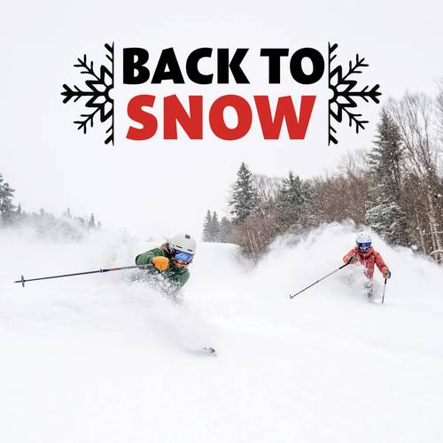 A woman skiing in a yellow jacket at Sunday River.