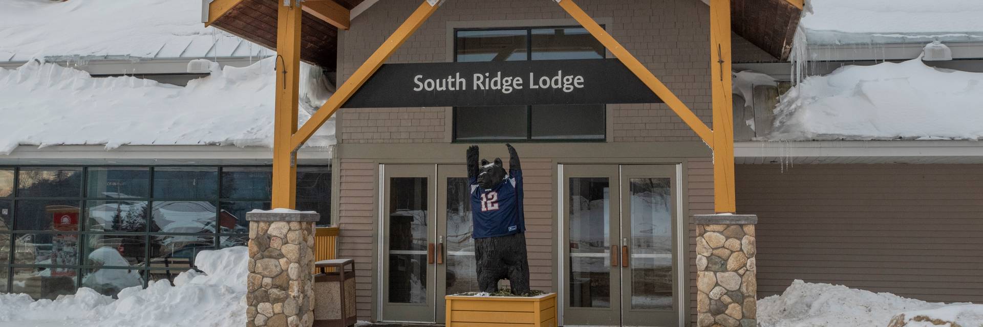 The bear in front of South Ridge Lodge at Sunday River wearing a Patriots jersey.
