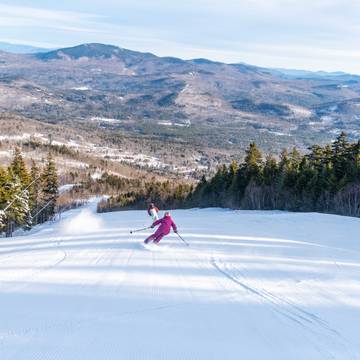 A woman skiing down a trail at Sunday River.