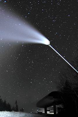 A snowgun making snow at Sunday River at night time.