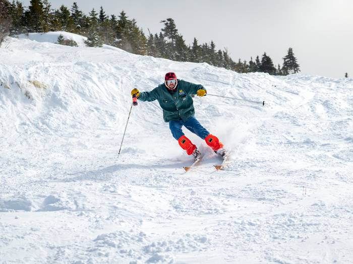 Donny Pelletier skiing with a bottle of Moxie