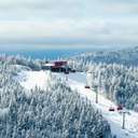 Barker 6 at Sunday River with snow covered trees and skiers.