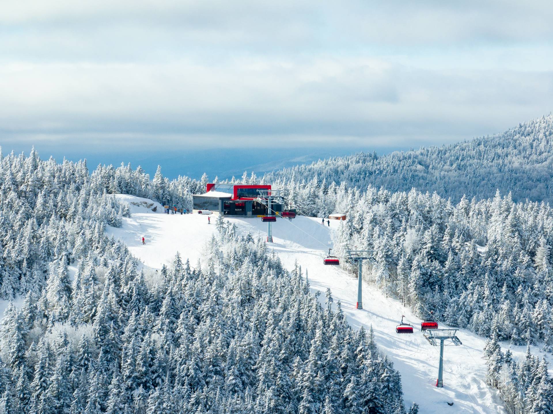 Barker 6 at Sunday River with snow covered trees and snowmaking in the background.