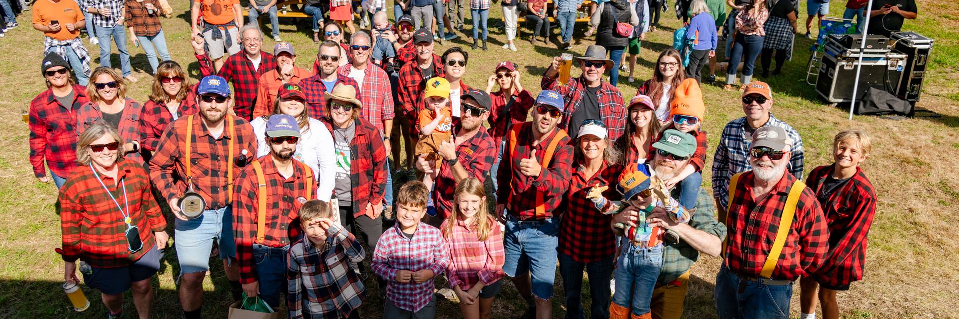 A group of people posing with Donny Pelletier at Sunday River in flannel outfits.