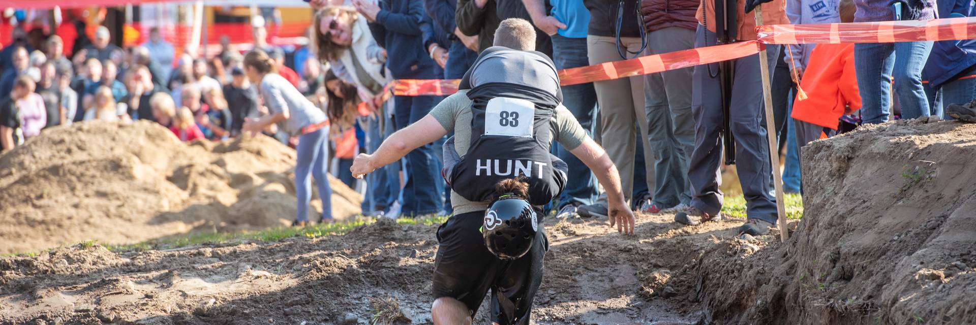 A man and woman participating in the North America Wife Carrying Competition at Sunday River Resort in Newry, Maine