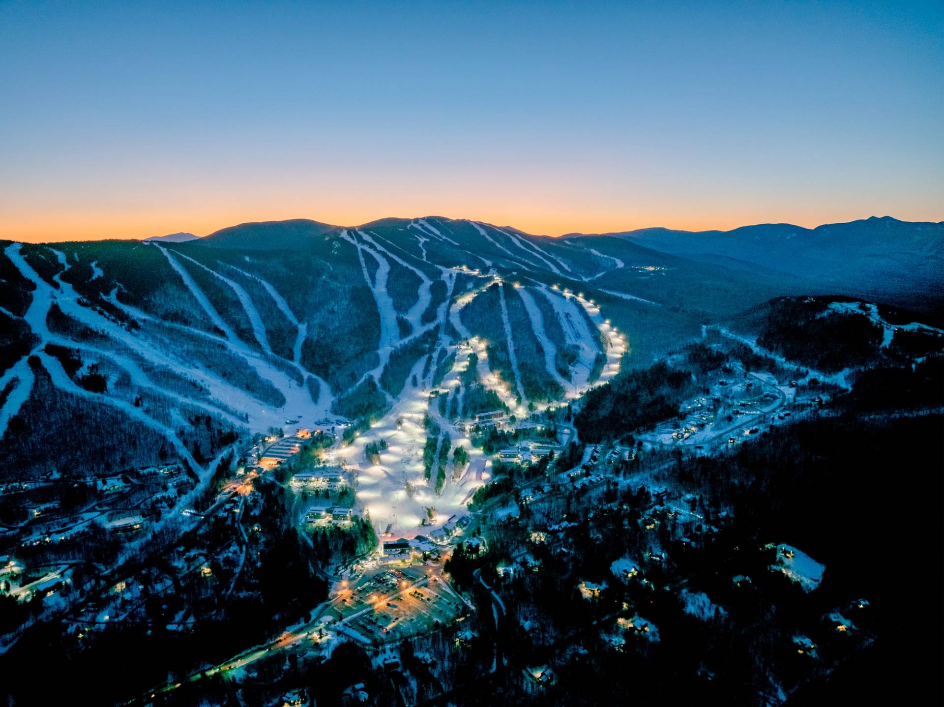 Trails at Sunday River at night time with lights for twilight skiing.