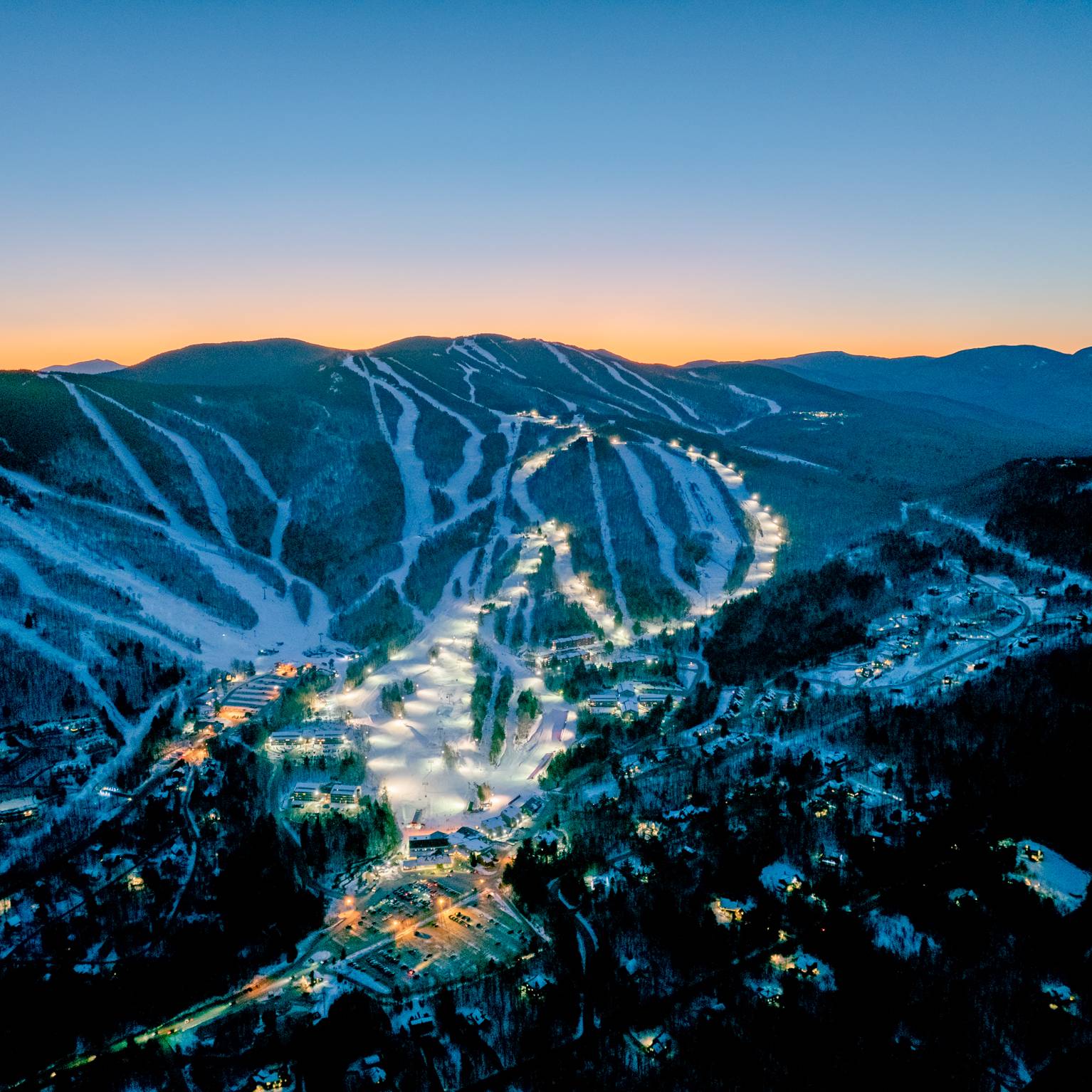 Trails at Sunday River at night time with lights for twilight skiing.