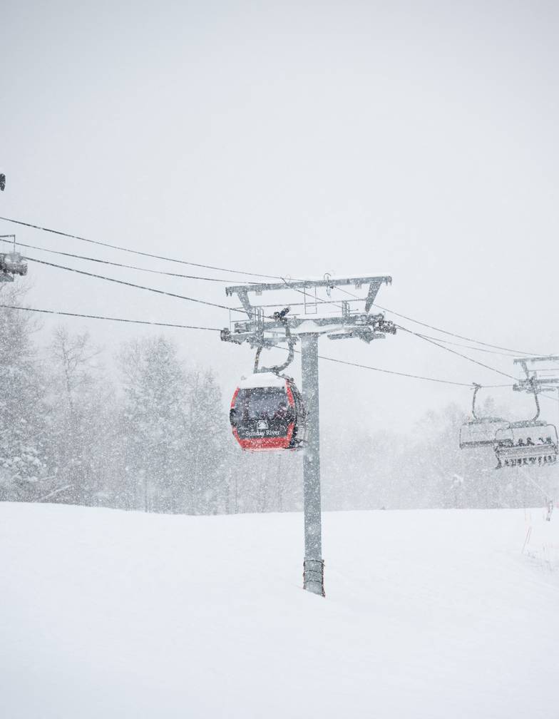 The Chondola lift at Sunday River on a snowy winter day.