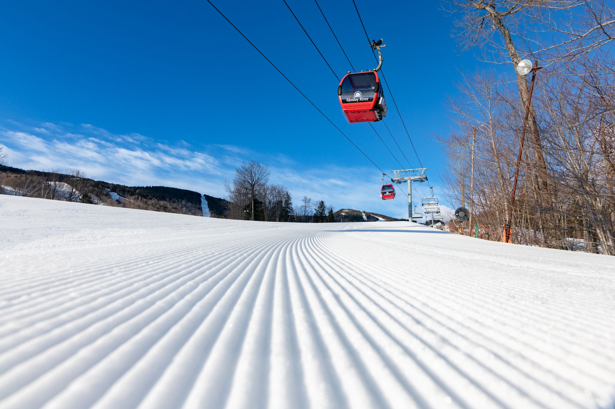 The Chondola at Sunday River spinning on a blue sky day in the winter. 