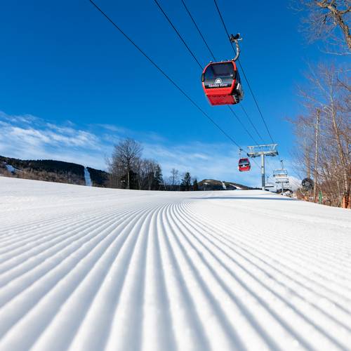 The Chondola at Sunday River spinning on a blue sky day in the winter.