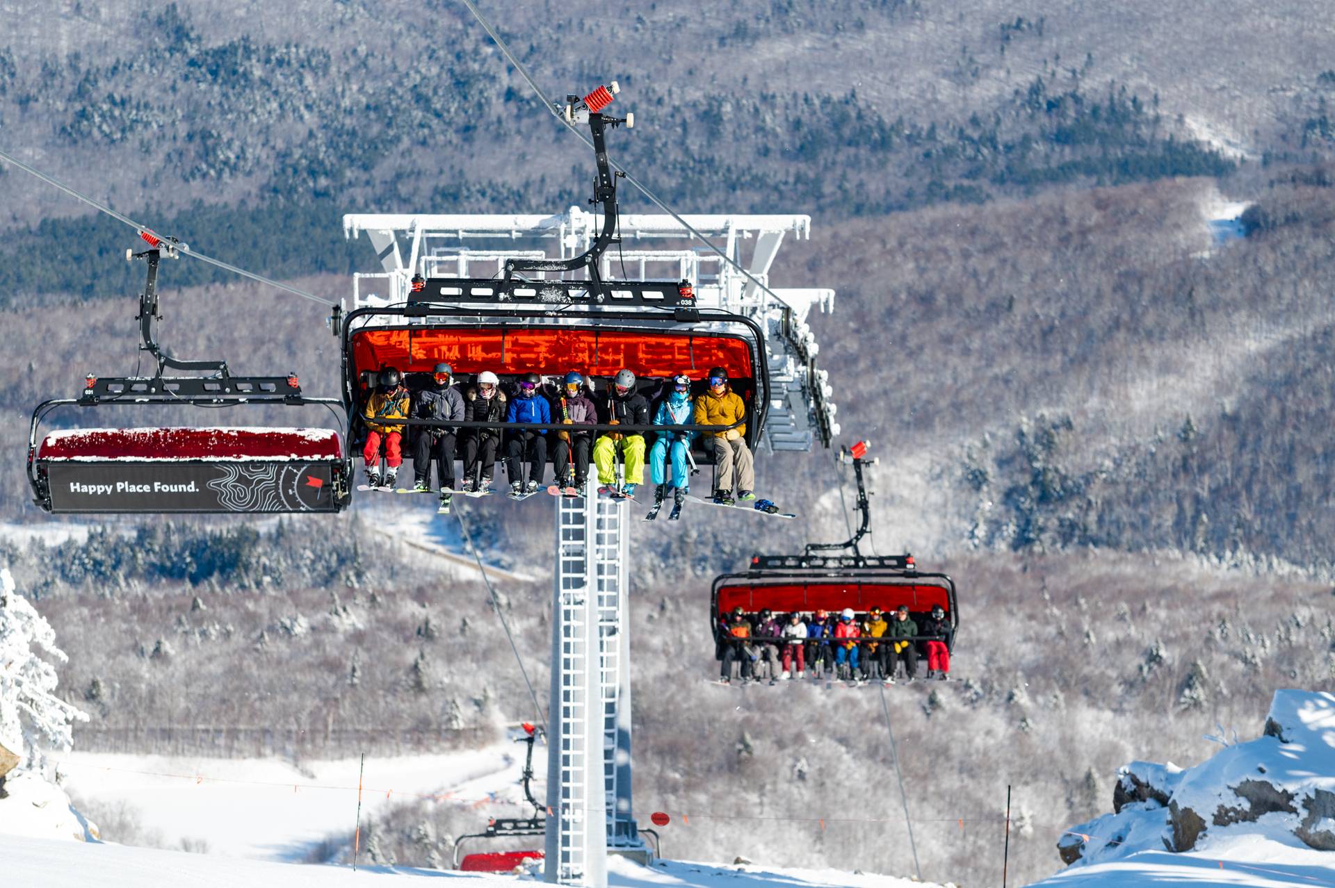 Skiers and riders sitting on the new Jordan 8 bubble lift at Sunday River.