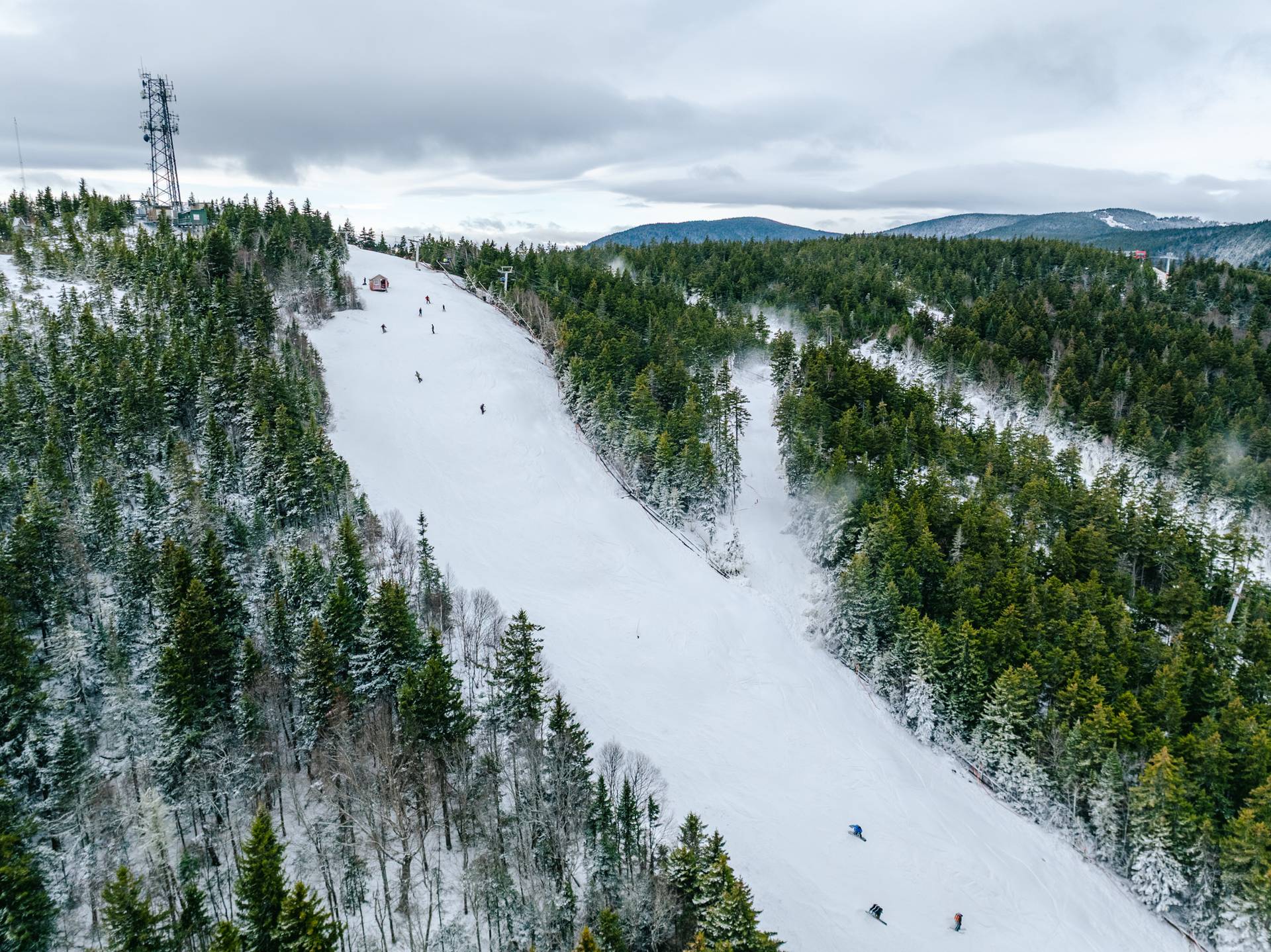People skiing down a trail for opening day at Sunday River.