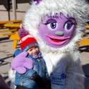 A kid hugging Betty the Yeti at Sunday River.