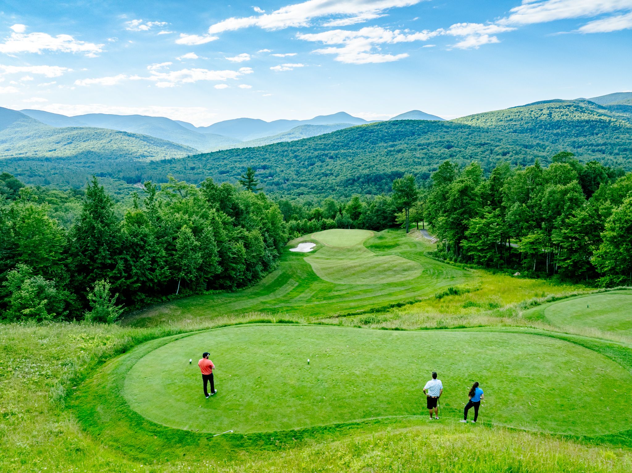 Sunday River Golf Club with people standing at one of the holes.