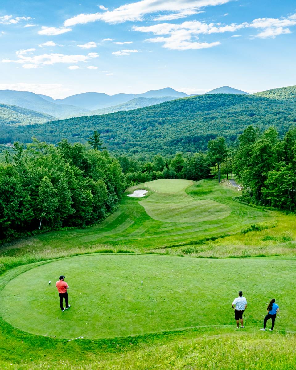 Sunday River Golf Club with people standing at one of the holes.