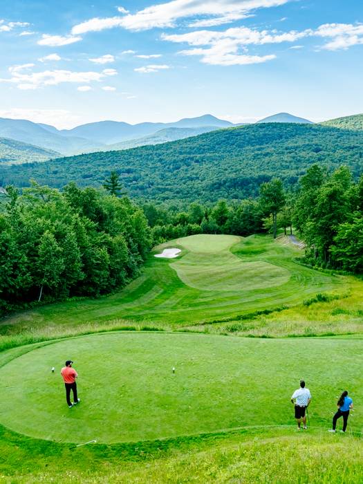 Sunday River Golf Club with people standing at one of the holes.