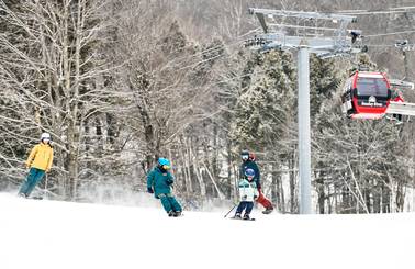 A family skiing at Sunday River.