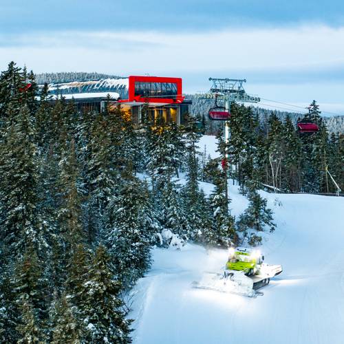 The barker 6 and a snowcat at dusk