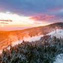 A sunrise at Sunday River with snowmaking underway.