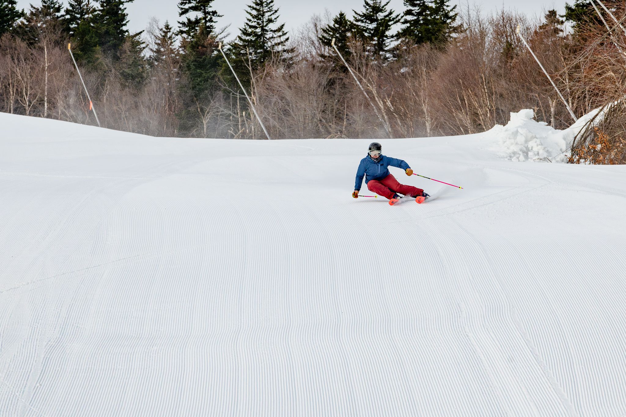 Skier carving a turn on fresh corduroy.