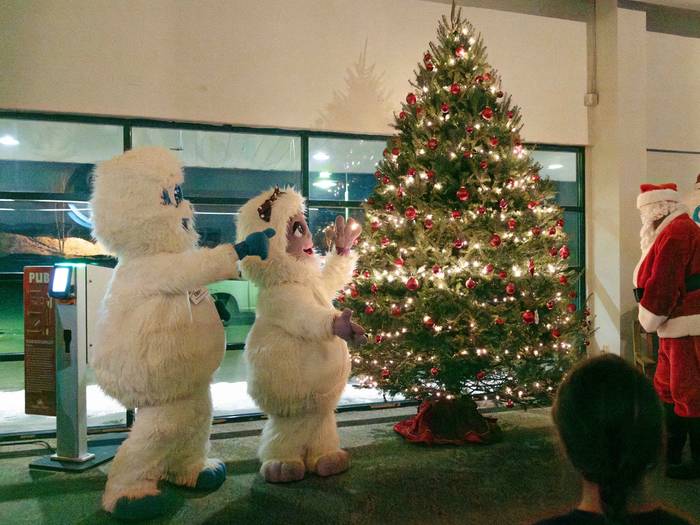 Eddy and Betty the Yetis presenting a Christmas tree at Sunday River.