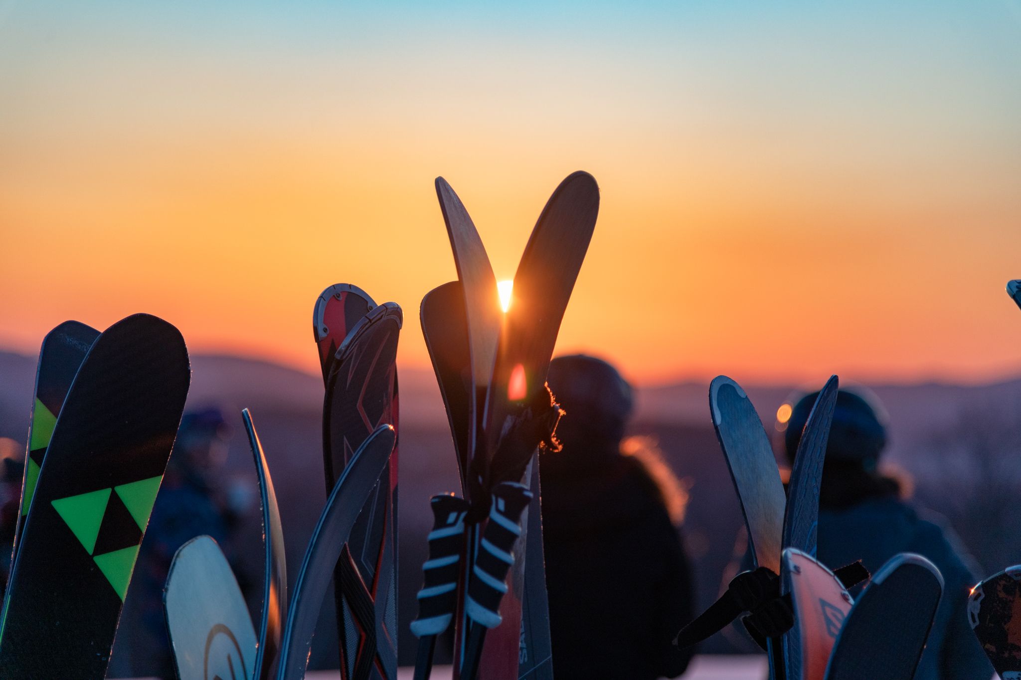 Skis on the rack at sunrise.
