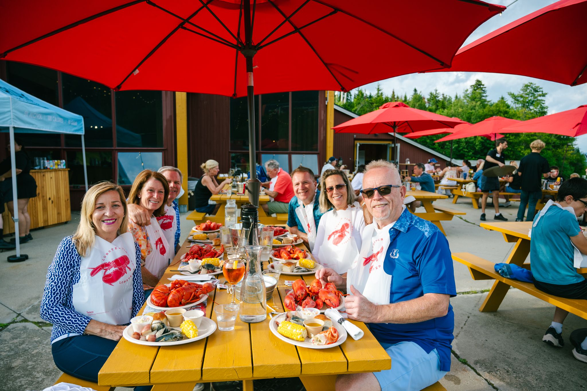 People sitting and enjoying the lobster bake at Sunday River.