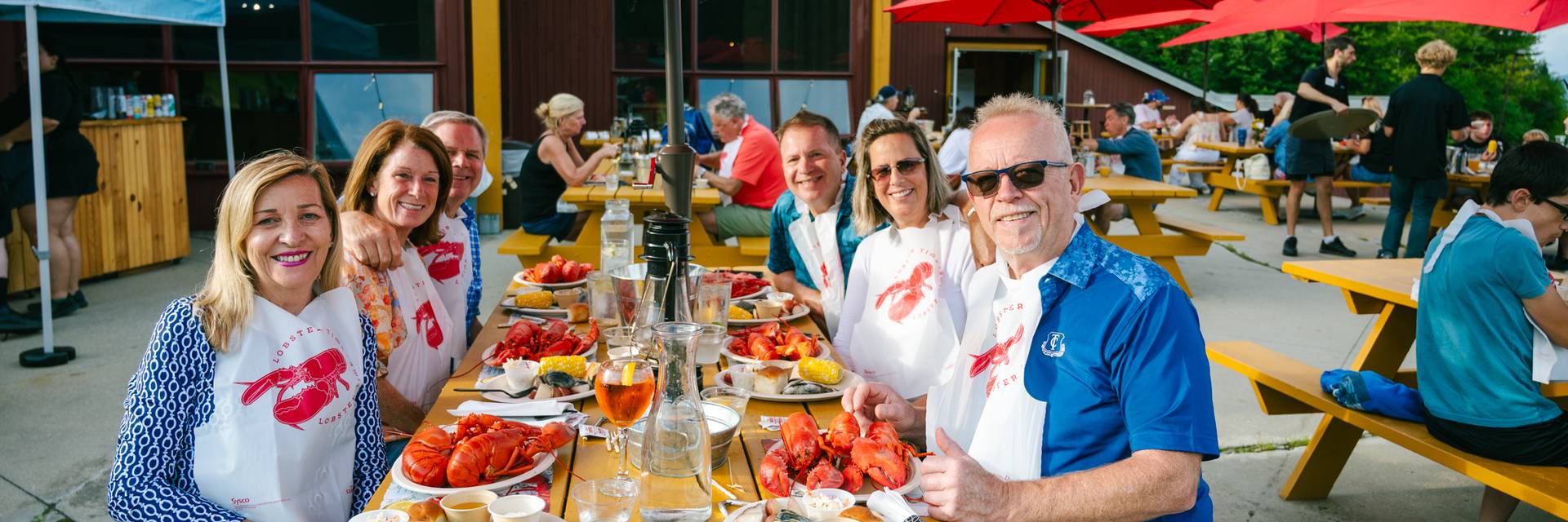 People sitting and enjoying the lobster bake at Sunday River.