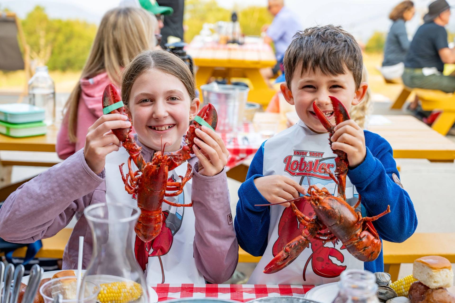 Kids holding up lobsters at Sunday River's Lobster Bake.