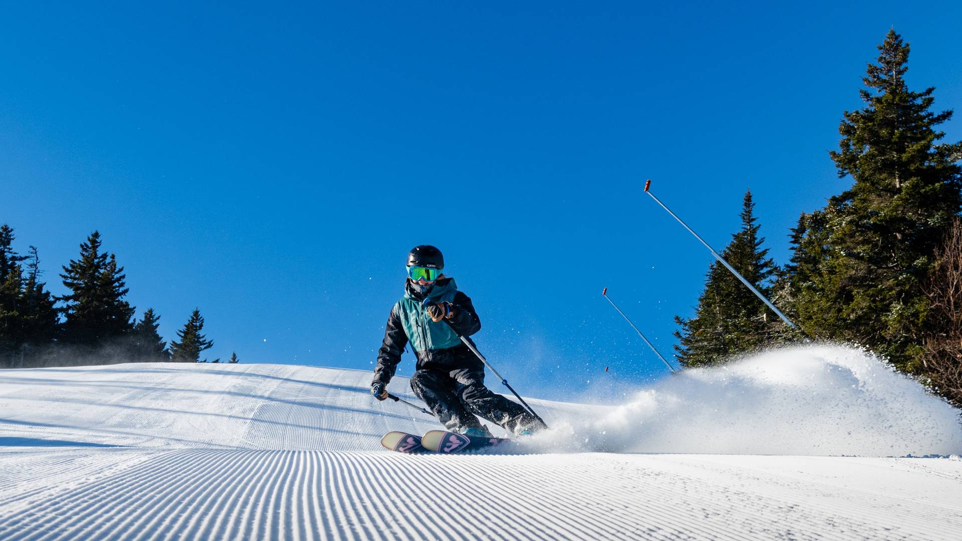 A person skiing under blue skies at Sunday River.