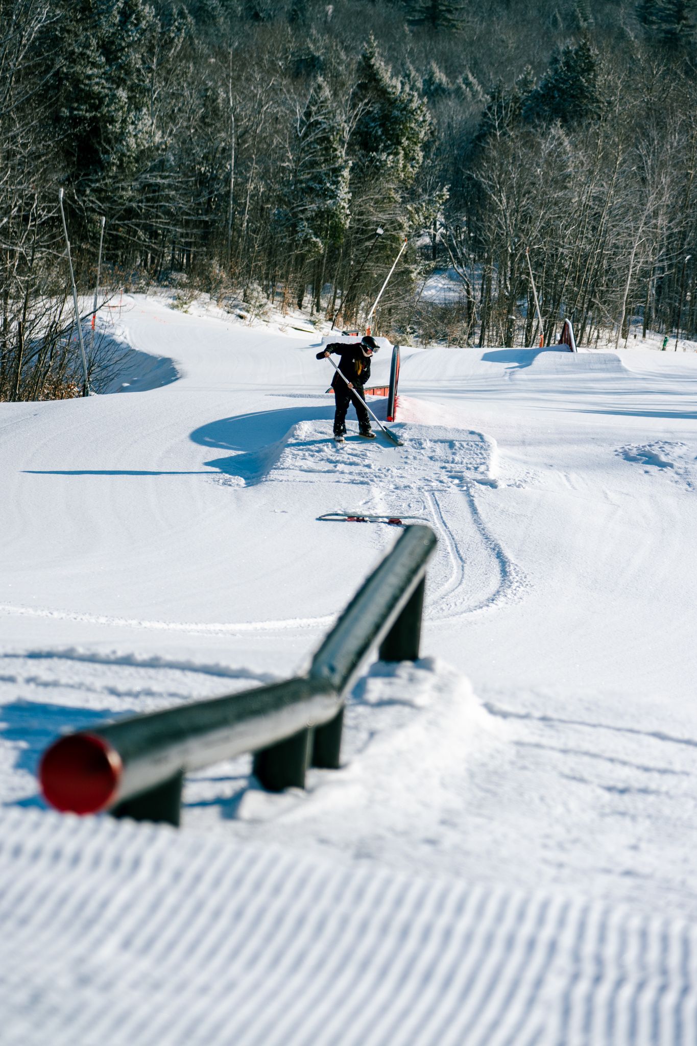 A person raking by park features at Sunday River.