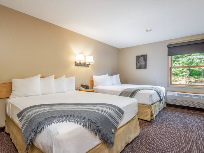 Two queen beds made at the Snow Capp Inn at Sunday River.